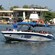 A passenger boat cruises around the bay of Cartagena, with the docks in the background